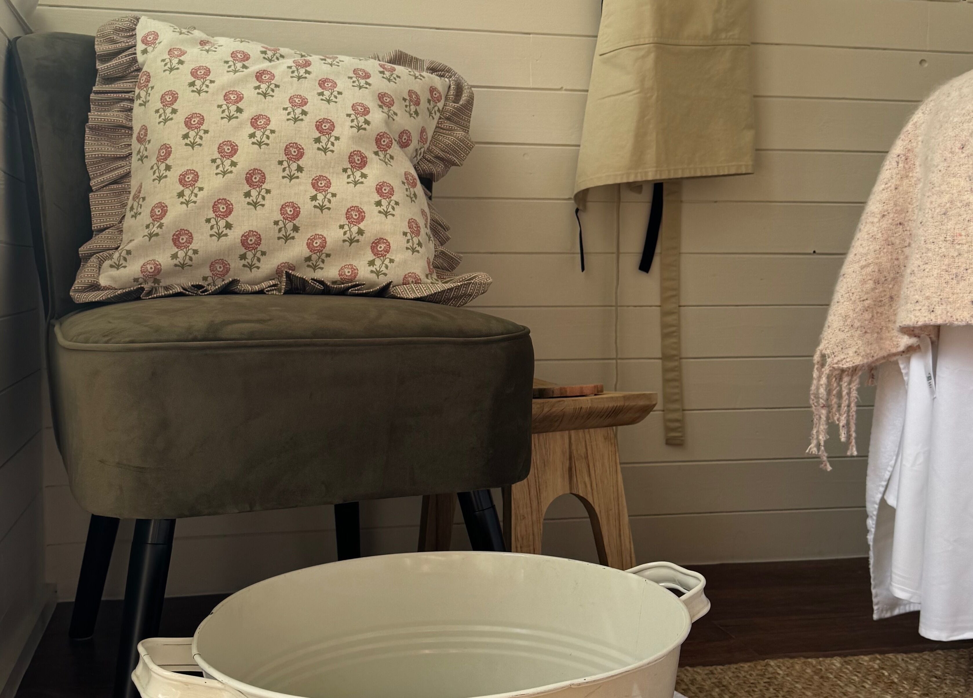 Cozy seating area in Wellness Studio, Bristol, England, GB with a plush chair and floral pillow.
