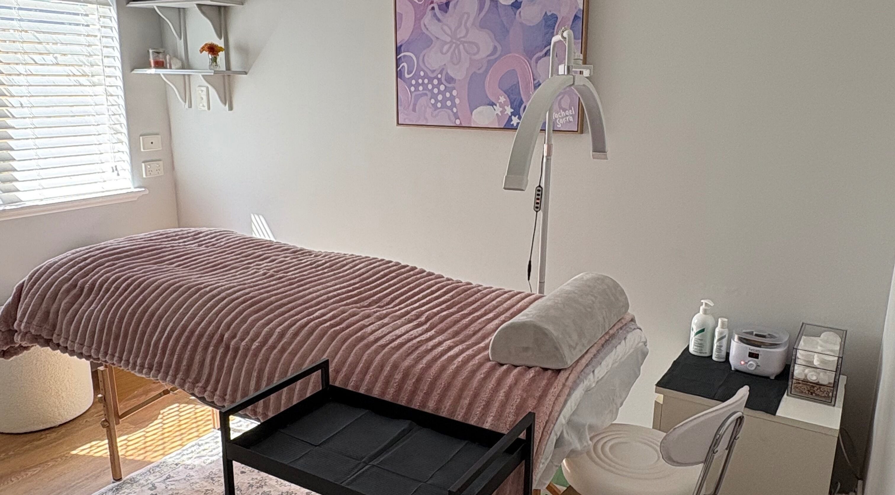 Tranquil treatment room at Eyes by Em, Greenfields, Western Australia, AU, featuring cozy bed and soft lighting.