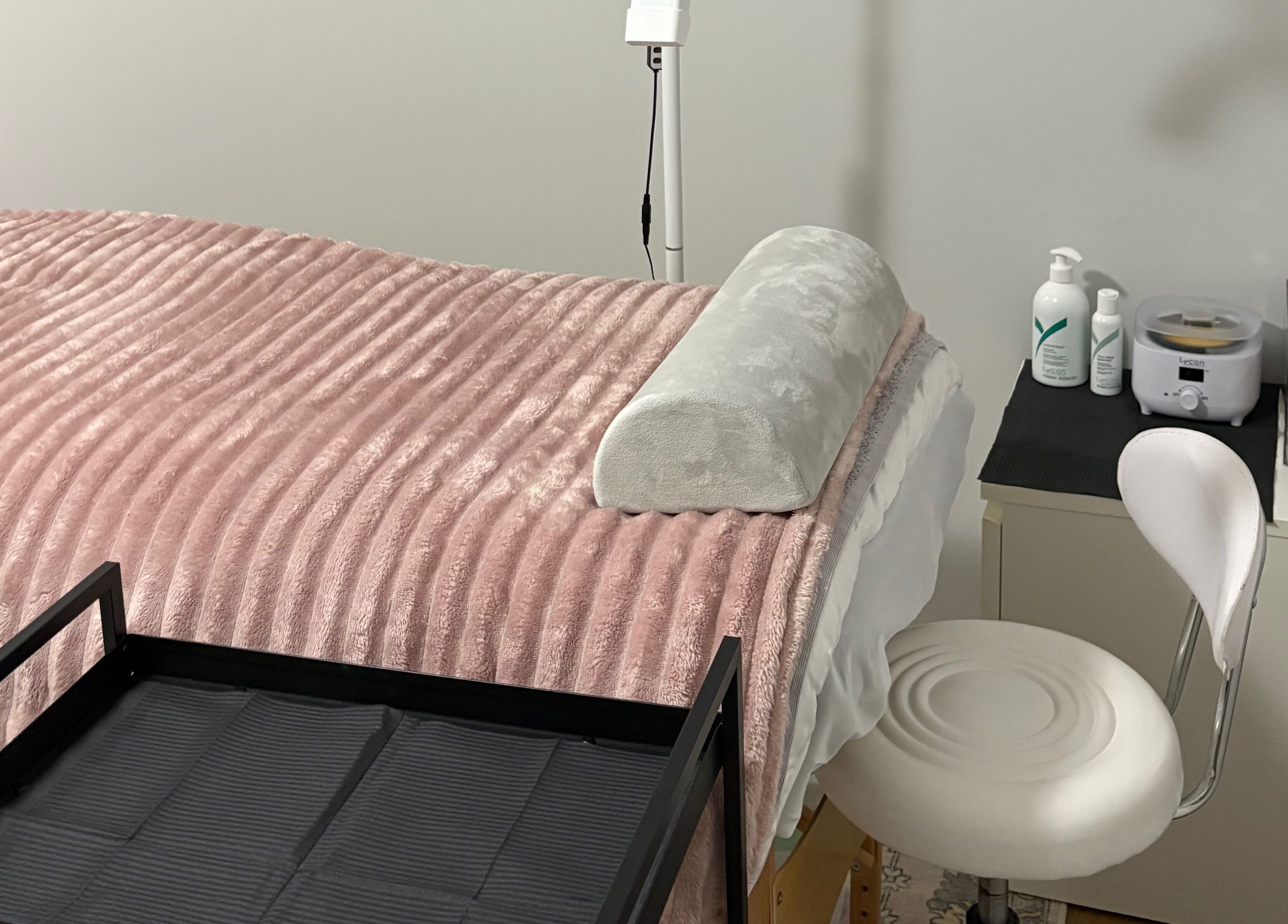 Cozy beauty treatment room at Eyes by Em in Greenfields, Western Australia, AU with plush pink blanket.