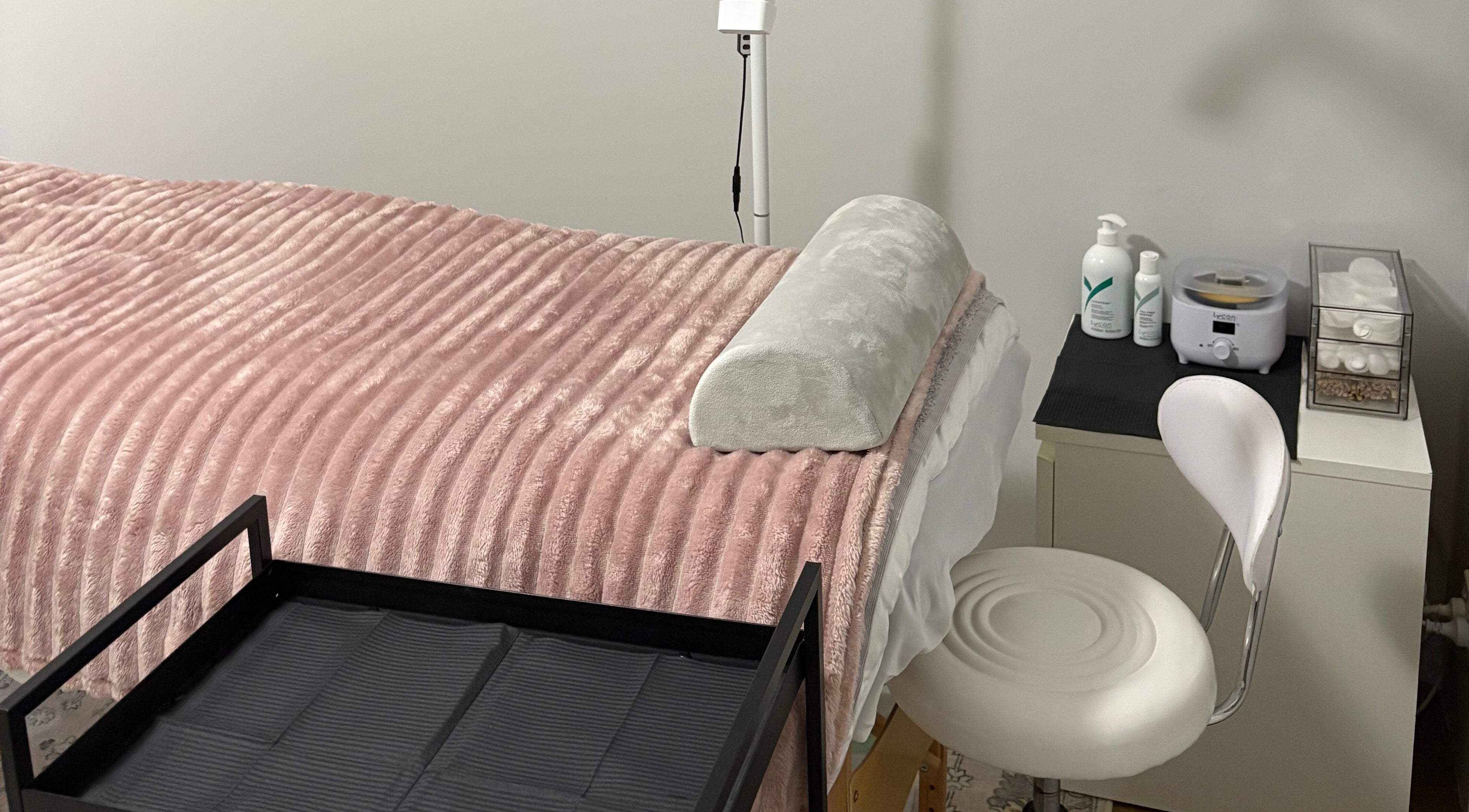 Cozy beauty treatment room at Eyes by Em in Greenfields, Western Australia, AU with plush pink blanket.