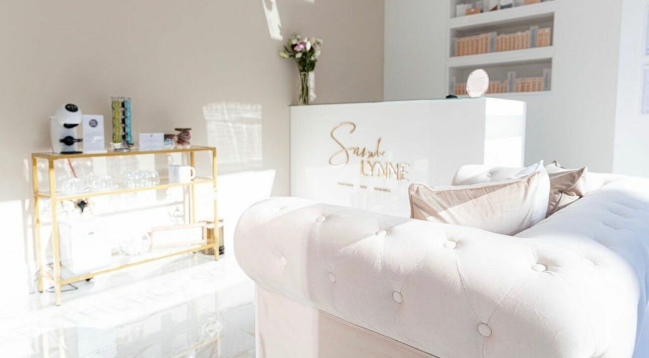 Elegant reception at Sarah Lynne Aesthetics, Porthmadog, Wales, GB with chic decor and plush seating.