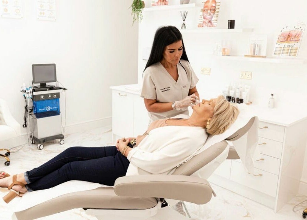 Professional aesthetician at Sarah Lynne Aesthetics in Porthmadog, Wales, GB, performing a facial treatment.