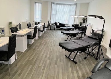 Modern beauty studio at Glammedbyamelia, Plymouth, England, GB with elegant manicure stations and treatment beds.