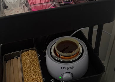 Glammedbyamelia beauty cart with wax warmer in Plymouth, England, GB, showcasing waxing tools and supplies.