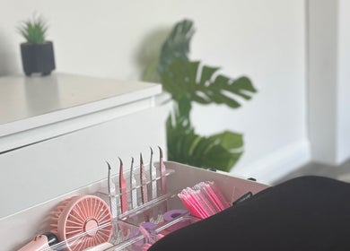Beauty tools on a vanity at Glammedbyamelia, Plymouth, England, GB, featuring tweezers and fan.
