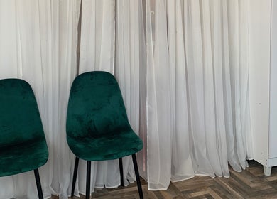 Emerald chairs against white curtains at OnHer by Melissa Studio, Trincity, Tunapuna/piarco Regional Corporation, TT.