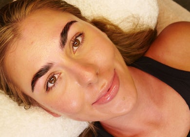 Woman showcasing styled brows at PRECISION LASH & BROW, Bethesda, Maryland, US.