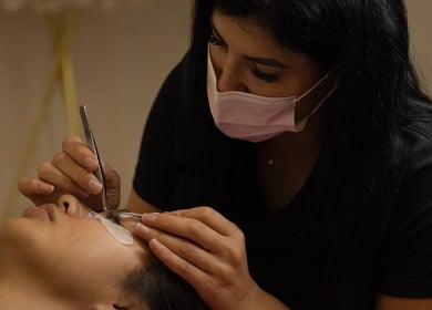 Technician applying eyelash extensions at PRECISION LASH & BROW, Bethesda, Maryland, US.