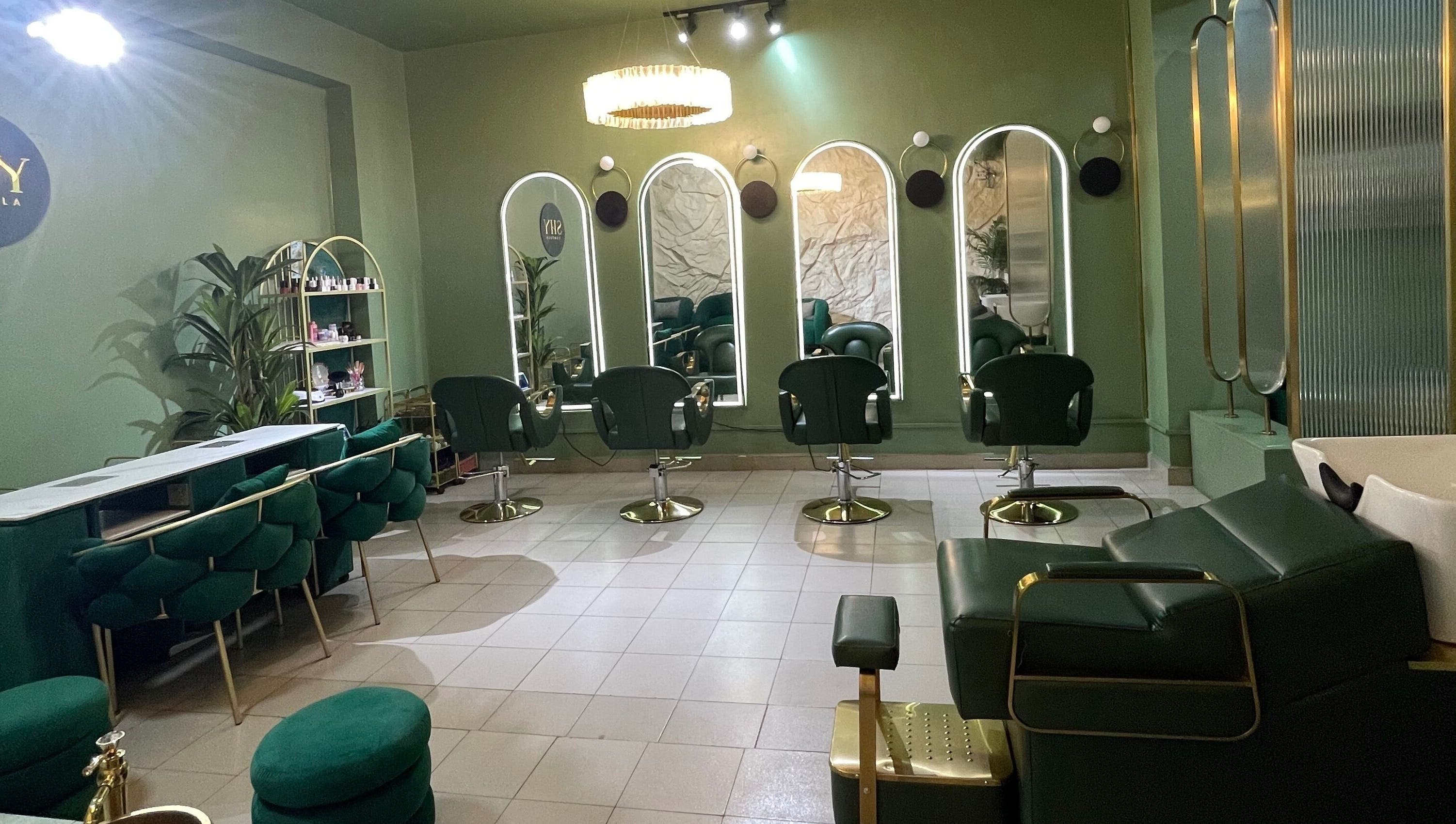 Chic interior of SHY KAMPALA BY MB in Kampala, Central Region, UG with stylish green seating and mirrors.