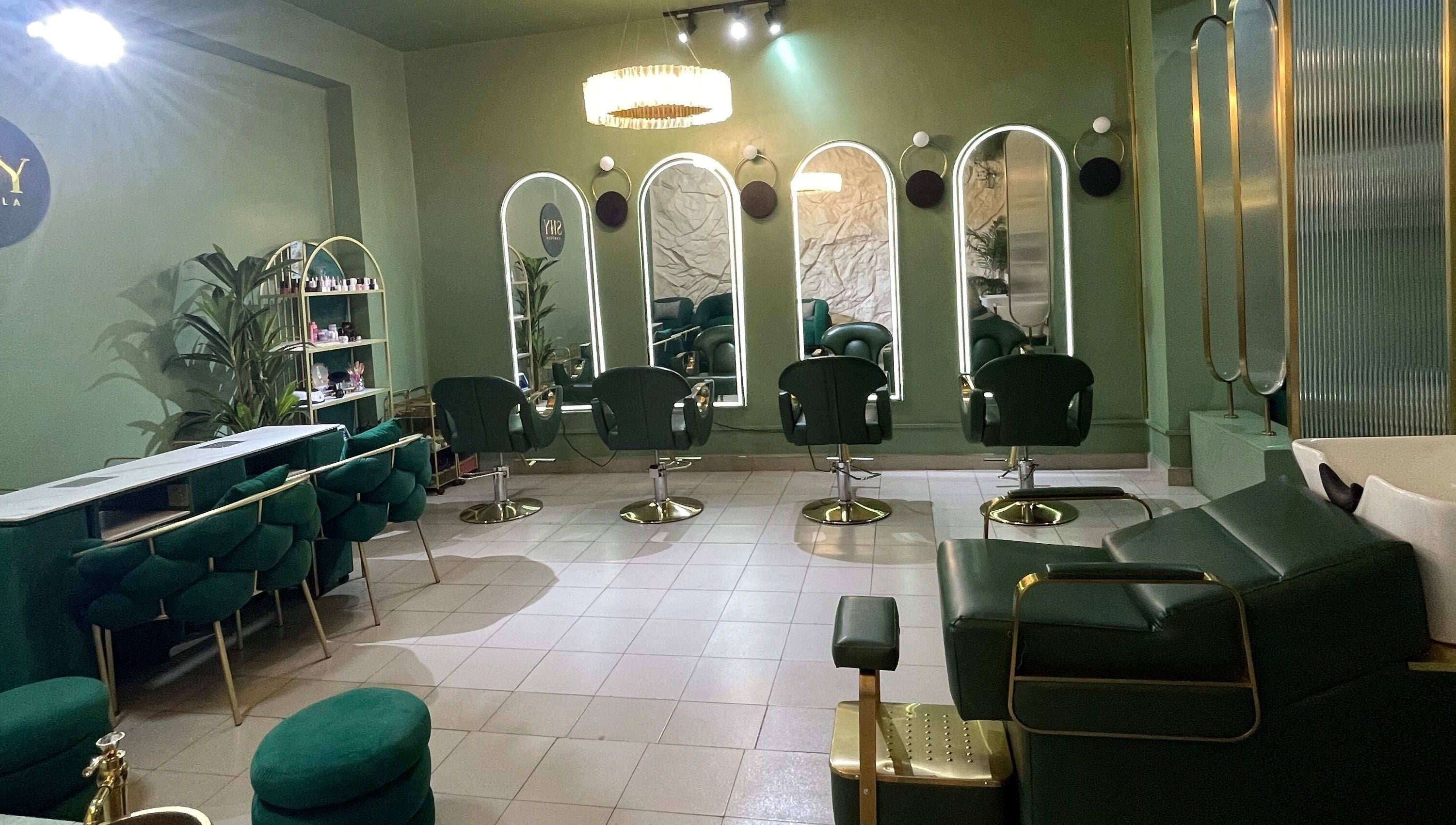 Chic interior of SHY KAMPALA BY MB in Kampala, Central Region, UG with stylish green seating and mirrors.