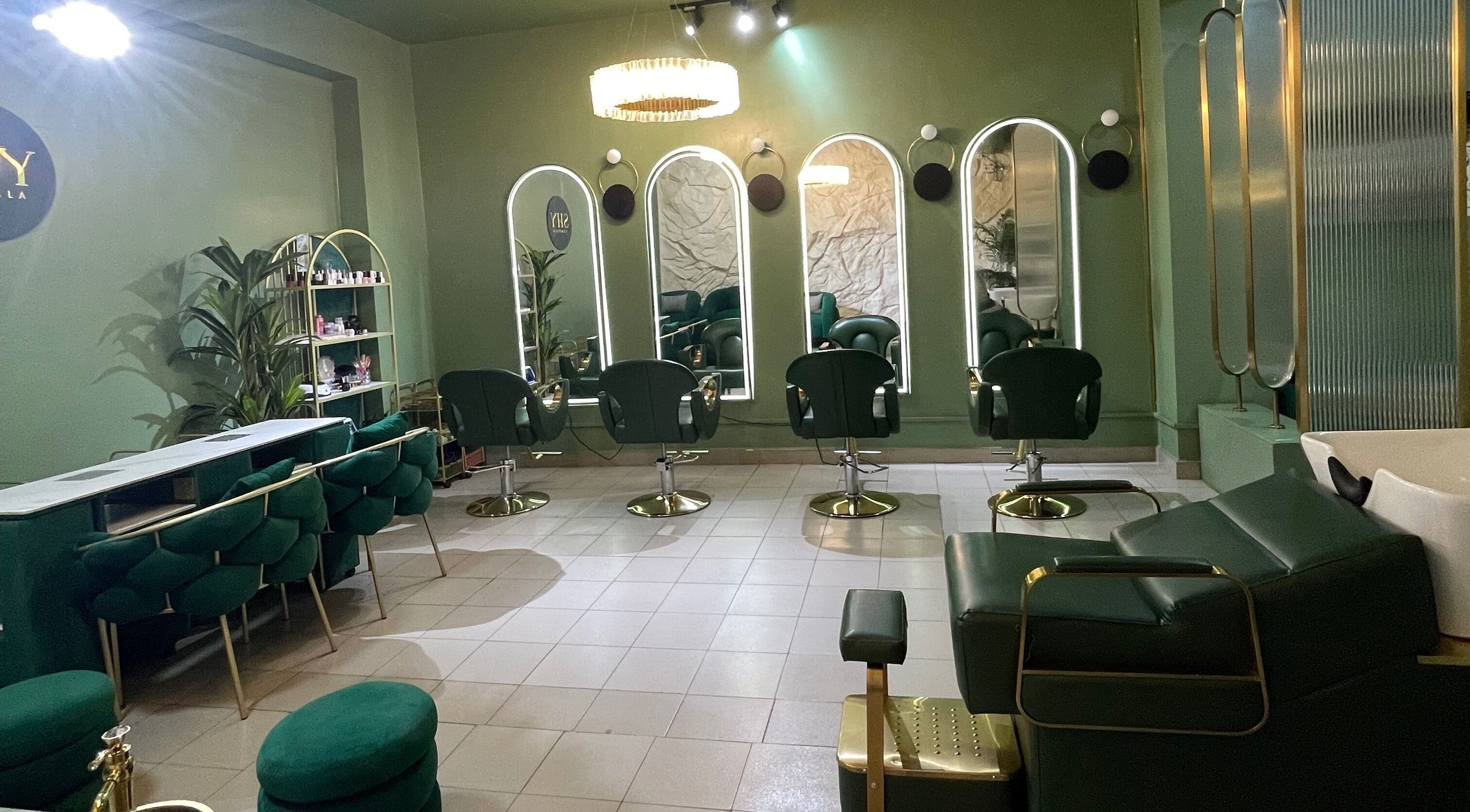 Chic interior of SHY KAMPALA BY MB in Kampala, Central Region, UG with stylish green seating and mirrors.