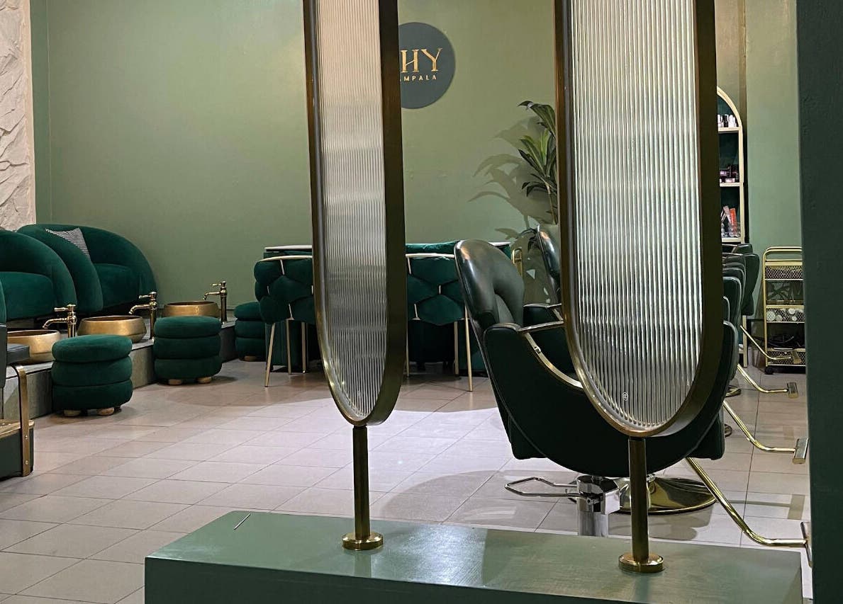 Chic interior of SHY KAMPALA BY MB, featuring green seating and gold fixtures, Kampala, Central Region, UG.