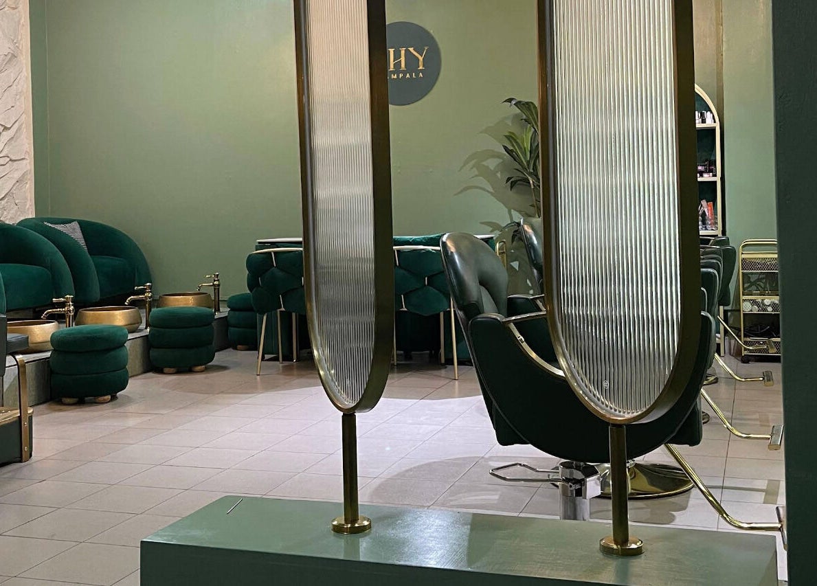 Chic interior of SHY KAMPALA BY MB, featuring green seating and gold fixtures, Kampala, Central Region, UG.