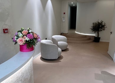 Sophisticated lounge area at GB BROWS, London, England, GB, featuring plush chairs and floral decor.