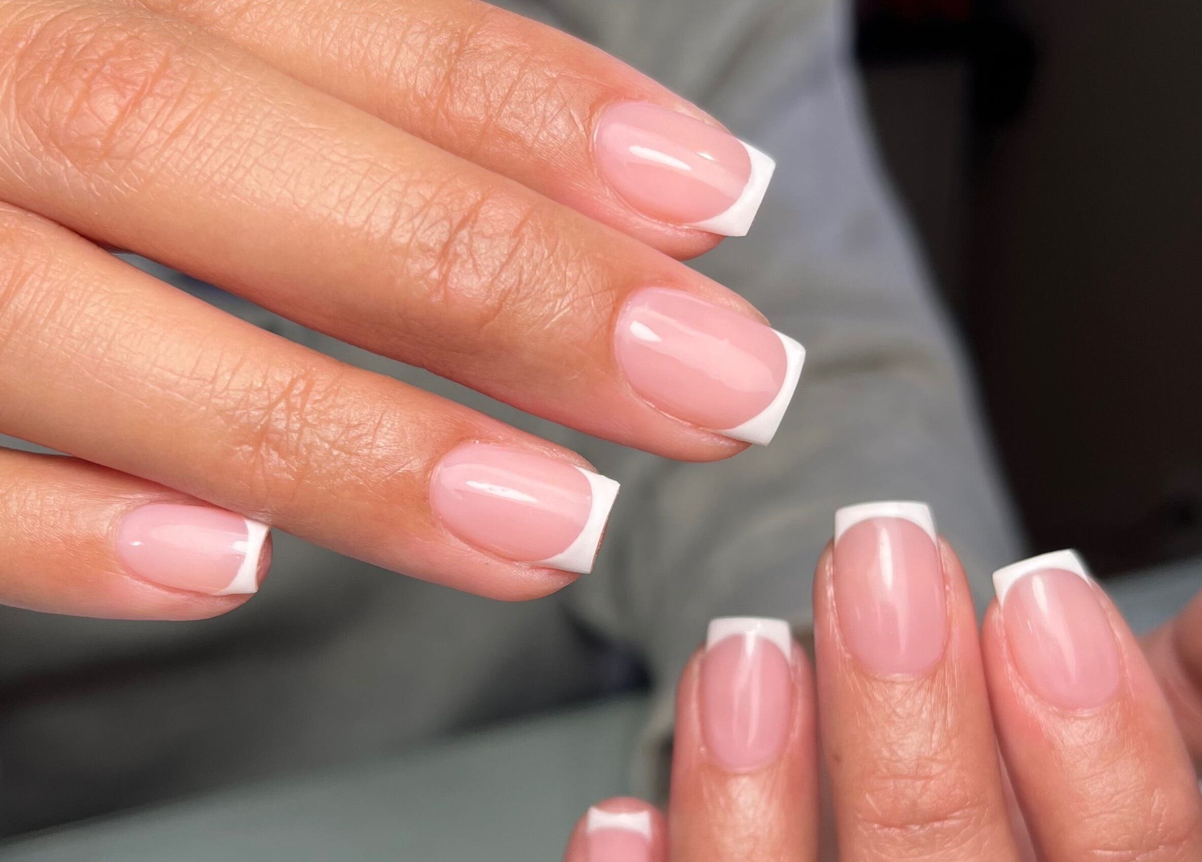 French manicure at Dainty Daggers Salon, Calgary, Alberta, CA. Perfectly polished nails display elegance.