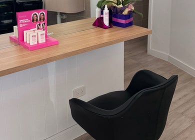 Styling chair and product display at Hair By Simone, Melbourne, Victoria, AU. Elegant salon ambiance captured.