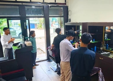 Point (north dagon) salon interior in Yangon, showing clients receiving haircuts and vibrant decor.