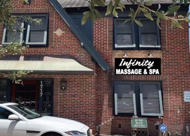 Infinity Massage & Spa brick facade located at 1717, Houston, Texas, US, captured on a sunny day.