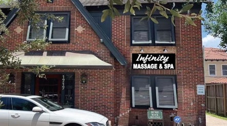 Infinity Massage & Spa brick facade located at 1717, Houston, Texas, US, captured on a sunny day.