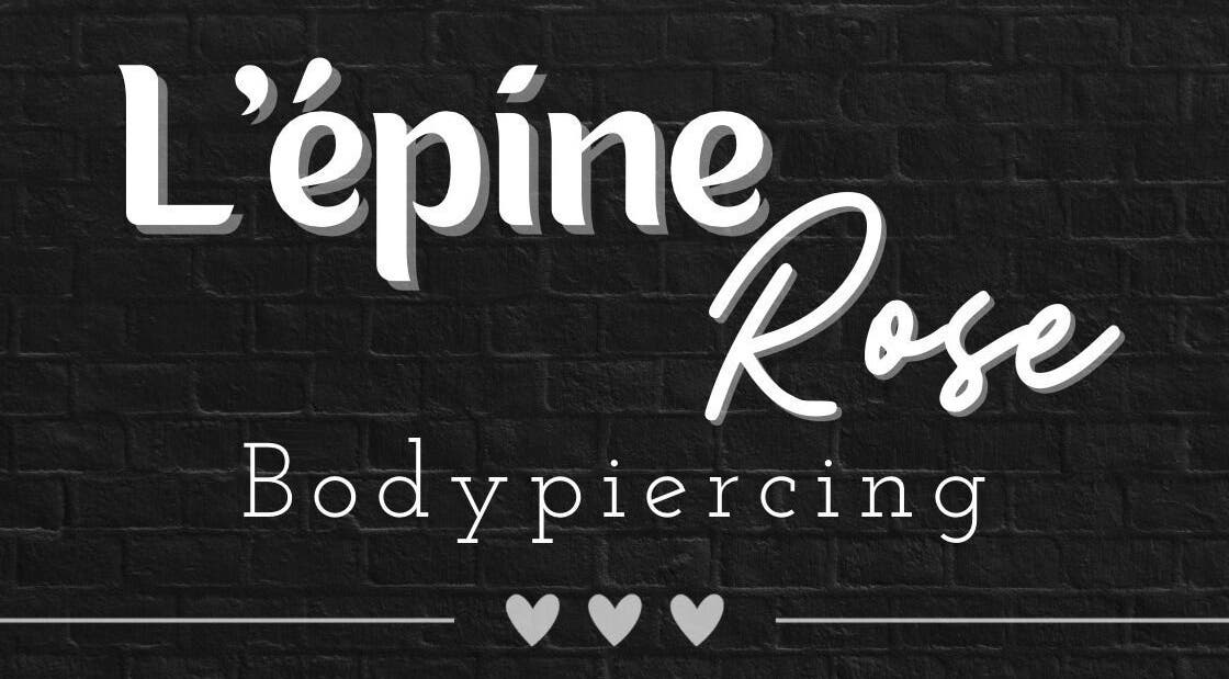 Logo lumineux de L’épine rose | Piercing à Bruille-saint-amand, Hauts-de-france, FR sur fond noir.