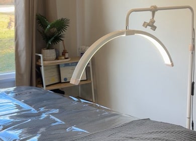Tranquil treatment room at Wild River Beauty, Walcha, New South Wales, AU, featuring a cozy bed and ambient lighting.