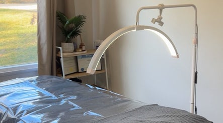 Tranquil treatment room at Wild River Beauty, Walcha, New South Wales, AU, featuring a cozy bed and ambient lighting.