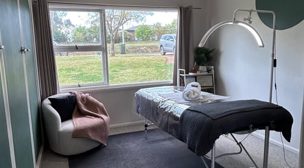 Calming therapy room at Wild River Beauty in Walcha, New South Wales, AU with massage table and cozy chair.