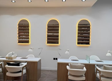 Modern nail stations at Diva Beauty Shop, Riyadh, Riyadh Province, SA, with illuminated shelves and chic decor.