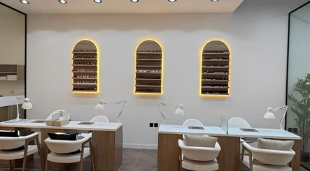 Modern nail stations at Diva Beauty Shop, Riyadh, Riyadh Province, SA, with illuminated shelves and chic decor.