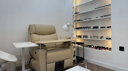 Elegant nail care station at Diva beauty shop, Riyadh, Riyadh Province, SA, featuring a plush chair and product display.