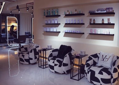 Modern salon interior at M hair and beauty, لوسيل, بلدية الضعاين, QA with stylish seating and product displays.
