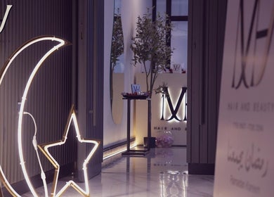 Elegant M hair and beauty entrance with moon and star decor, located at لوسيل, بلدية الضعاين, QA.