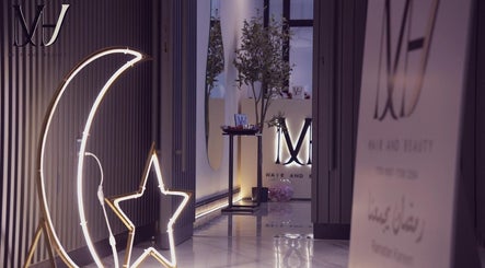 Elegant M hair and beauty entrance with moon and star decor, located at لوسيل, بلدية الضعاين, QA.