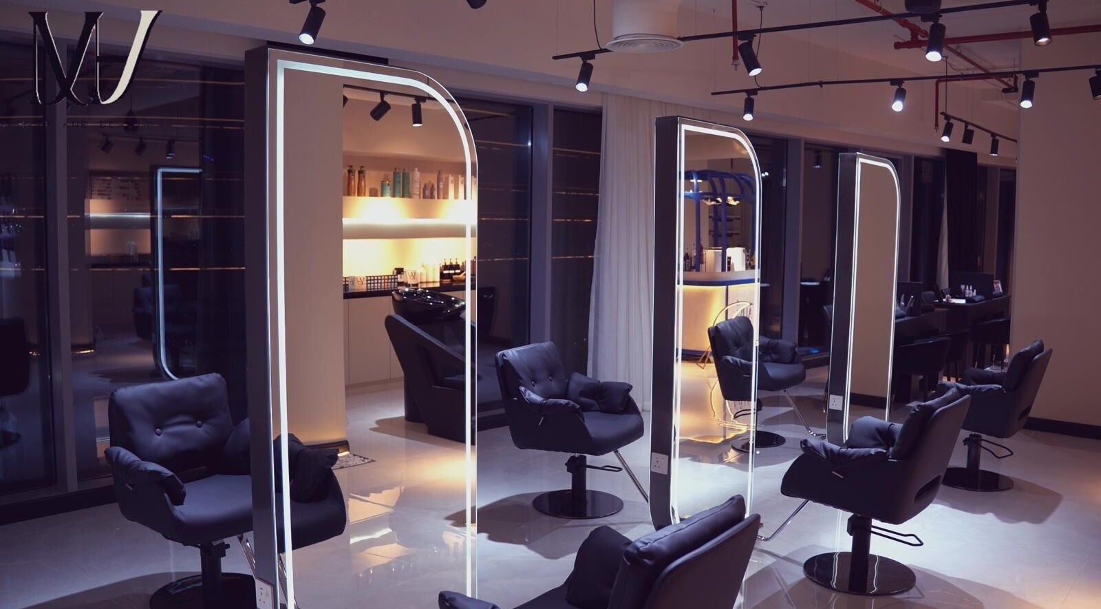 Luxurious interior of M hair and beauty salon in لوسيل, بلدية الضعاين, QA featuring modern styling chairs.