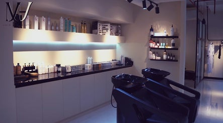 Modern interior of M hair and beauty salon in لوسيل, بلدية الضعاين, QA with elegant product display.