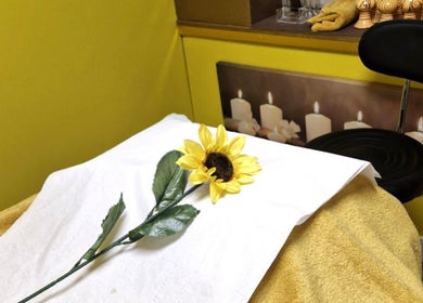 Massage table with sunflower at Ying Yang Thai Massage, Aberdeen, Scotland, GB, offering tranquil wellness.