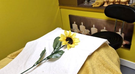 Massage table with sunflower at Ying Yang Thai Massage, Aberdeen, Scotland, GB, offering tranquil wellness.