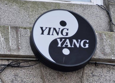 Ying Yang Thai Massage signage on a stone wall in Aberdeen, Scotland, GB.