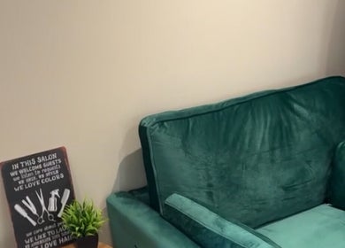 Comfortable green couch and decor at At home with Jade, Lincoln, England, GB, creating a relaxing salon atmosphere.