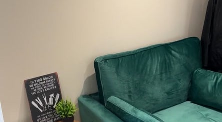 Comfortable green couch and decor at At home with Jade, Lincoln, England, GB, creating a relaxing salon atmosphere.