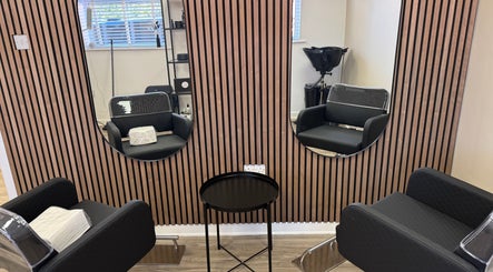 Sleek salon interior at Gary Sedgwick, Clitheroe, England, GB, with styling chairs and mirrors.