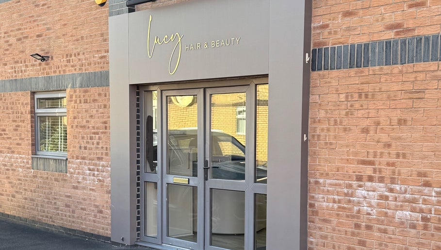 Exterior of Gary Sedgwick beauty salon in Clitheroe, England, GB with modern glass doors.