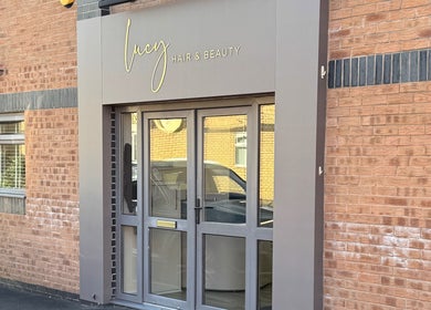 Exterior of Gary Sedgwick beauty salon in Clitheroe, England, GB with modern glass doors.