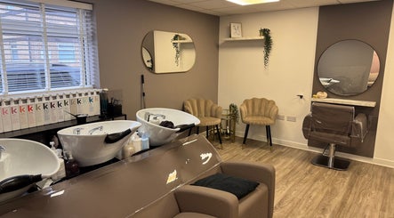Stylish salon interior at Gary Sedgwick, Clitheroe, England, GB with modern seating and hair wash stations.