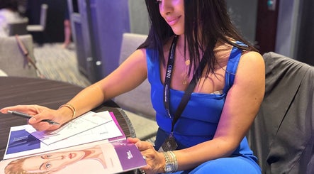 A woman in blue dress planning treatments at Routine Contour Clinic- Women Only, Melbourne, Victoria, AU.
