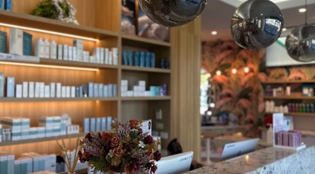 Routine Contour Clinic- Berwick, Melbourne's lush reception area, showcasing beauty products and floral decor.