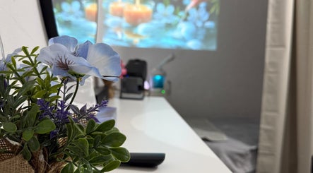 Serene spa room at Glam Onwheel, Leicester, England with fresh flowers and calming decor.