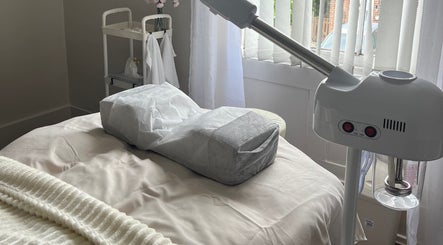 Relaxing spa room at Abbey Beauty Care, Minster, England, GB, with cozy bed and facial steamer.