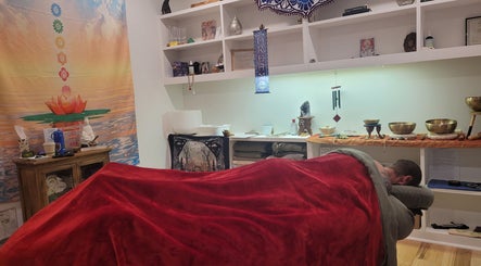 Cozy wellness room at Playground For The Soul, Winston-Salem, North Carolina, with massage table and serene decor.