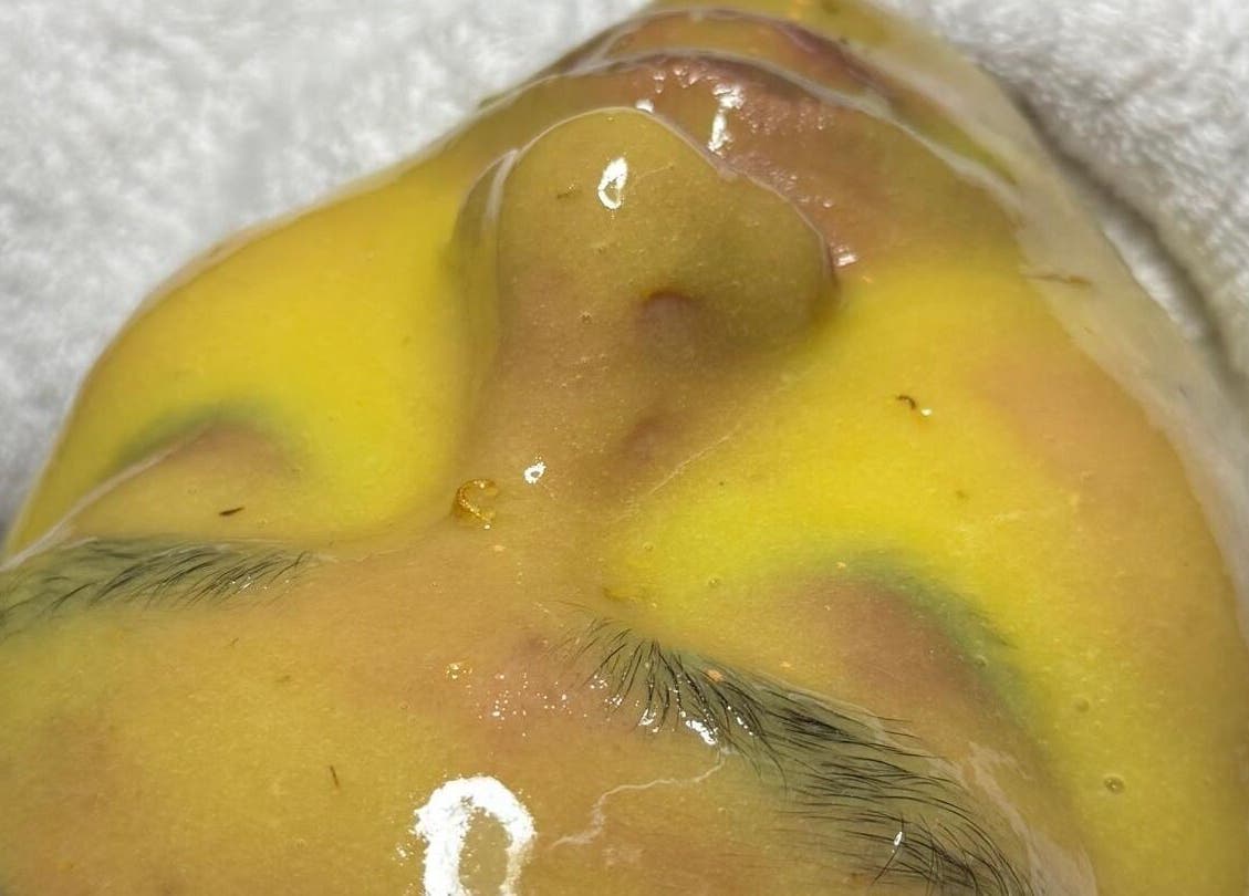 Luxurious facial treatment at Rainoura by Nurain Firdaus, Rawang, Selangor, MY, showcasing a vibrant yellow mask.